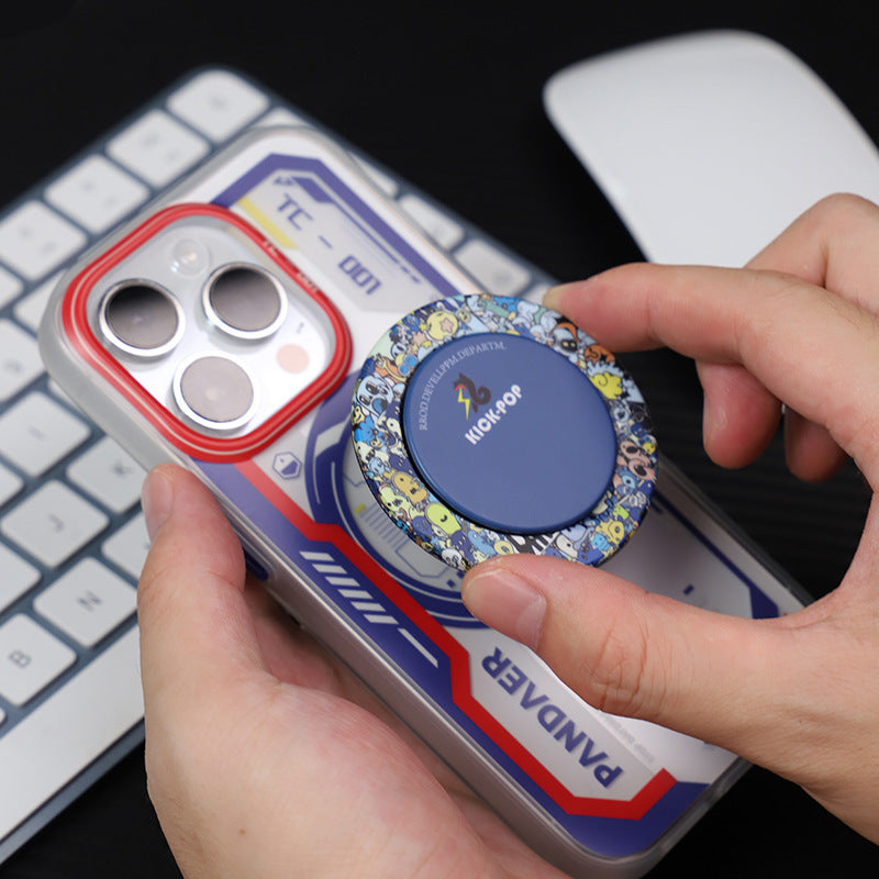 Person using ultra-thin magnetic phone holder on a smartphone with a stylish design and keyboard in the background.